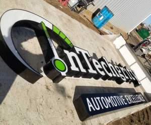 InTechgrity Automotive Excellence sign on flatbed